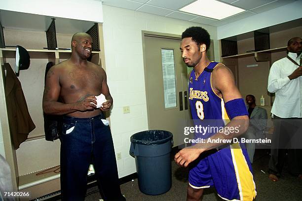 Kobe Bryant of the Los Angeles Lakers shares a laugh with teammate Shaquille O'Neal in the locker room after taking on the Indiana Pacers during Game...