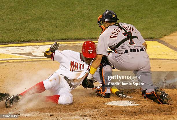 National League All-Star Alfonso Soriano of the Washington Nationals gets tagged out at home American League All-Star Ivan Rodriguez of Detroit...