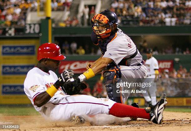 National League All-Star Alfonso Soriano of the Washington Nationals gets tagged out at home American League All-Star Ivan Rodriguez of Detroit...