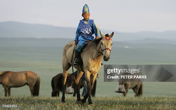 Young Mongolian rider heads out to the start of a gruelling 30km horse race during the annual Naadam Festival at Khui Doloon Khudag 40km from the...