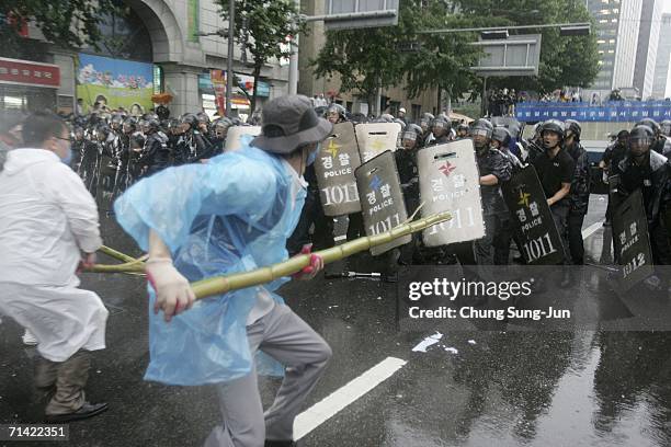 South Korean protester clashes with riot police during a anti-FTA rally on July 12, 2006 in Seoul, South Korea. Top U.S. And South Korean negotiators...