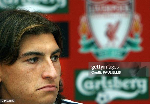 Liverpool, UNITED KINGDOM: Argentine centre-back Gabriel Paletta listens as Liverpool soccer manager Rafael Benitez welcomes him to the club, 12 July...