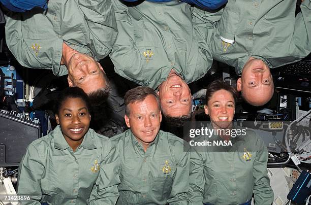 In this handout from NASA, The Space Shuttle Discovery crewmembers pose crew photo in the Destiny laboratory of the International Space Station. Are...