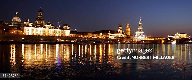 Picture taken 31 August 2005 shows paddlers on the Elbe river in front of the skyline of the historic old town of Dresden, eastern Germany. The...