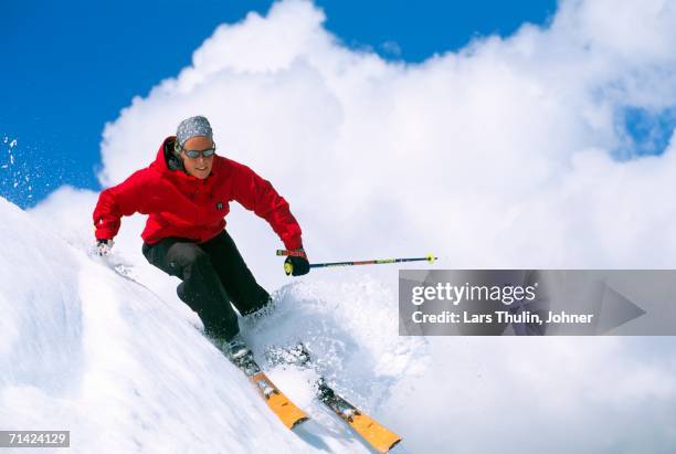 a skier skiing at high speed. - alpine skiing stock pictures, royalty-free photos & images