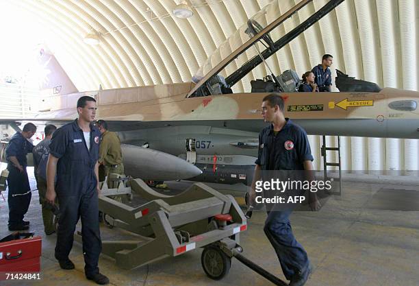 Israel: Israeli airforce mechanics load missiles onto an F-16 jet fighter in a hanger at the Ramat David air force base in northern Israel, 12 July...