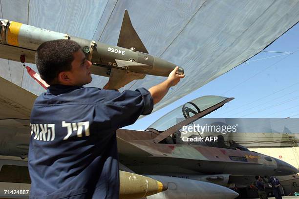 Israel: An Israeli airforce mechanic readies an F-16 jet fighter in a hanger at the Ramat David air force base in northern Israel, 12 July 2006. In...