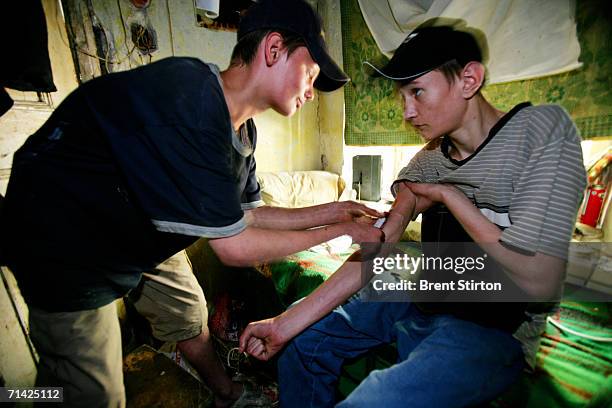 Streetkids shoot up in a condemn house on August 21, 2005 in Odessa, Ukraine. They are using a needle and syringe that were lying on the floor of the...