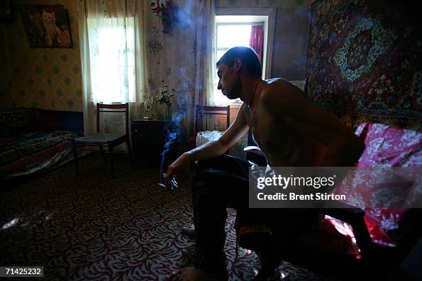 Sergei relaxes after shooting up in his groin with a local poppy-seed derived drug with a street name of Shiva on August 17, 2005 in Donetsk,...