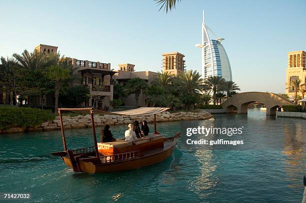 view of madinat jumeirah seen from the lake - madinat jumeirah hotel stock pictures, royalty-free photos & images