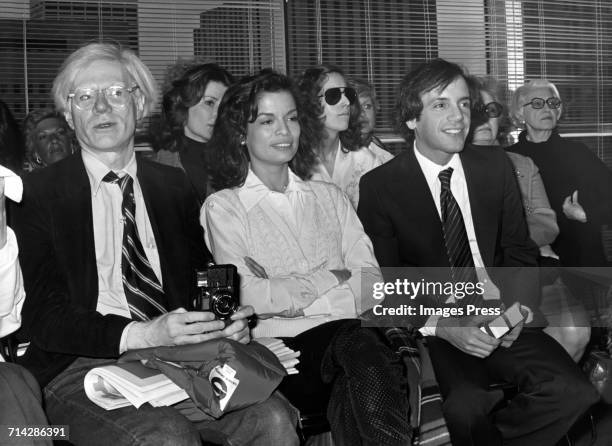 Andy Warhol, Bianca Jagger and Steve Rubell attend a Halston fashion show circa 1978 in New York City.