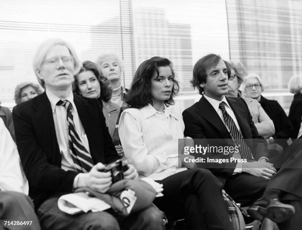 Andy Warhol, Bianca Jagger and Steve Rubell attend a Halston fashion show circa 1978 in New York City.