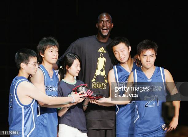 Kevin Garnett of the Minnesota Timberwolves poses with Chinese NBA fans during a commercial event on July 13 in Beijing, China.