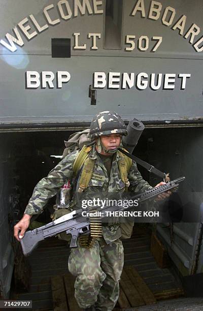 Philippine Marine in full combat gear disembark from a navy ship at the Bongao port in the Tawi Tawi group of islands, 13 July 2006. Some 400 troops...