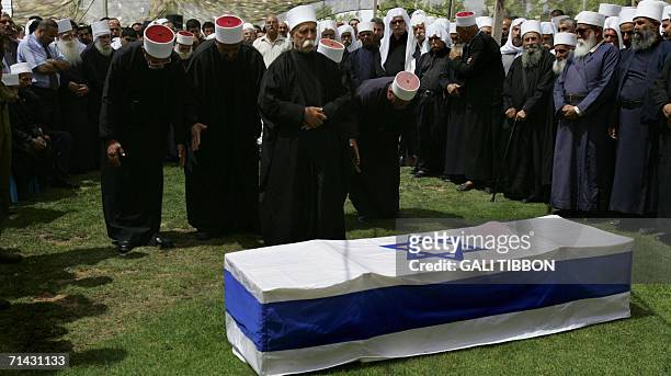 Druze clergy men pray over the coffin of slain Israeli defence force soldier 25-year-old First Sergeant Wasim Salah Nazal during his funeral in the...