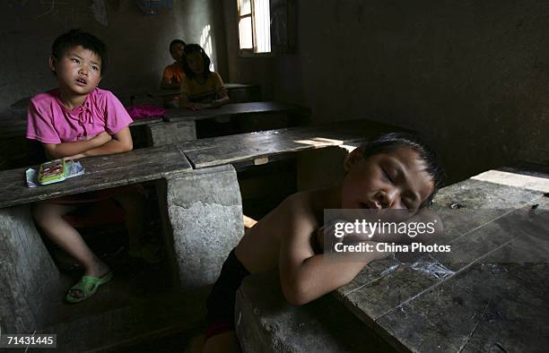Adopted children attend a class at Wang Jiayu Orphanage of Sanshilipu Village on July 11, 2006 in Yingshang County of Anhui Province, China. Wang...