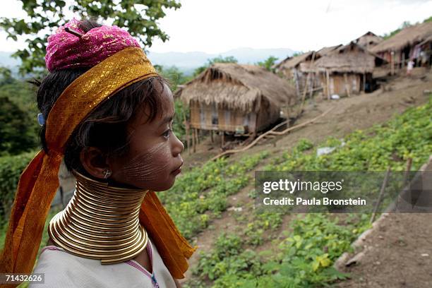 Mah Koh a Long Neck Padaung hill tribe, stands near her home in a small village where 30 familes live July 13, 2006 in Chiang Dao, Thailand. All the...