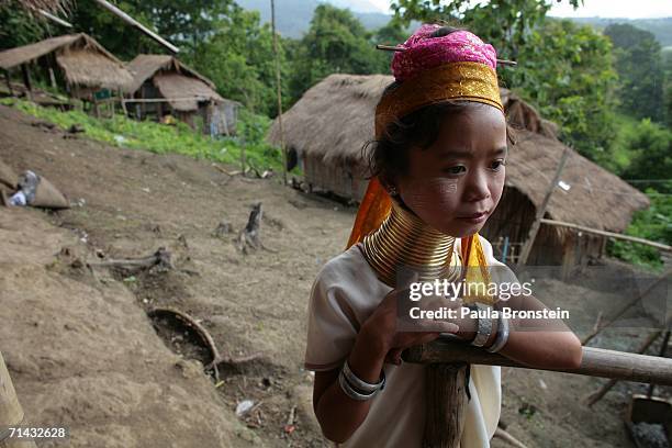 Mah Koh a Long Neck Padaung hill tribe, stands near her home in a small village where 30 familes live July 13, 2006 in Chiang Dao, Thailand. All the...