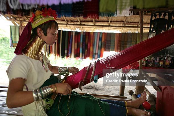 Mah Chan, a Long Neck Padaung hill tribe woman weaves a scraf for sale to tourists in a small village where 30 familes live July 13, 2006 in Chiang...