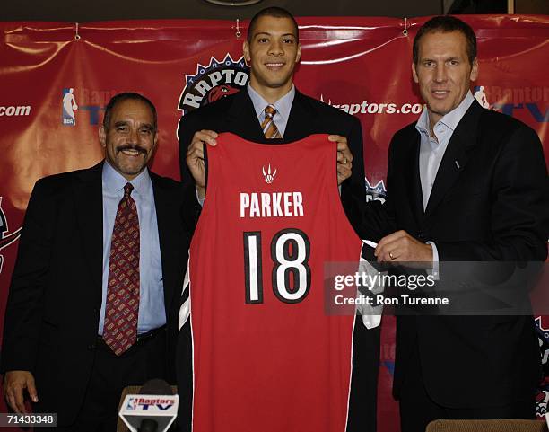 Agent Henry Thomas, Anthony Parker and General Manager Bryan Colangelo of the Toronto Raptors poses for the media during Parker's signing press...