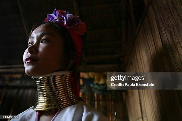 Mah Su,1 9, a Long Neck Padaung hill tribe woman poses inside her home July 13, 2006 in Chiang Dao, Thailand. All the Long Neck villages are set up...