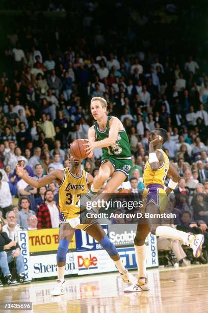 Brad Davis of the Dallas Mavericks shoots a short jump shot against Magic Johnson of the Los Angeles Lakers during a game played in 1988 at the Great...