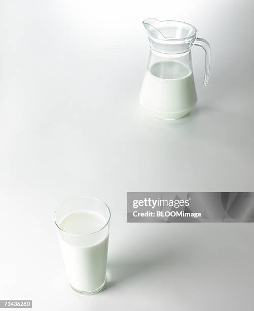 grass of milk and pitcher of milk - milk pitcher ストックフォトと画像