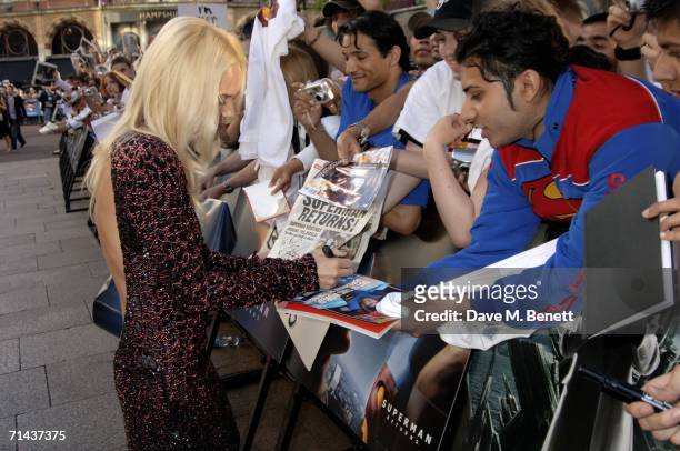 Actress Kate Bosworth signs autographs for fans as she arrives at the UK premiere of "Superman Returns" at Odeon Leicester Square on July 13, 2006 in...
