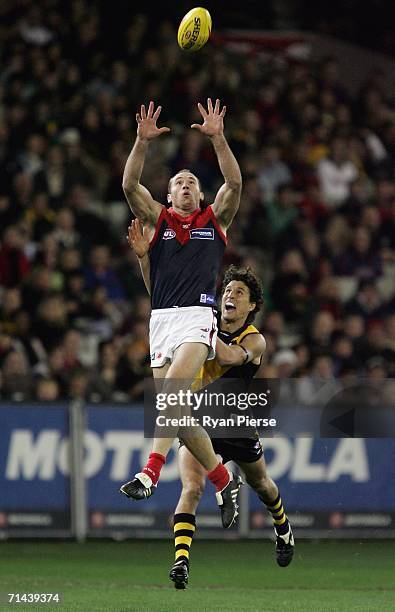 David Neitz of the Demons marks in front of Darren Gaspar of the Tigers during the round 15 AFL match between the Richmond Tigers and the Melbourne...