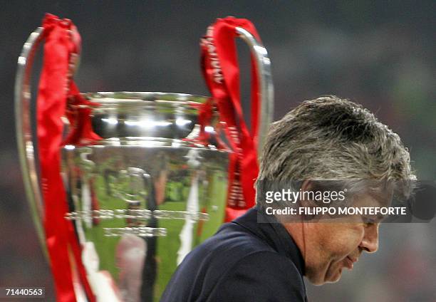 - Picture taken 25 May 2005 of AC Milan's coach Carlo Ancelotti walking by the throphy at the end of the UEFA Champions league football final AC...