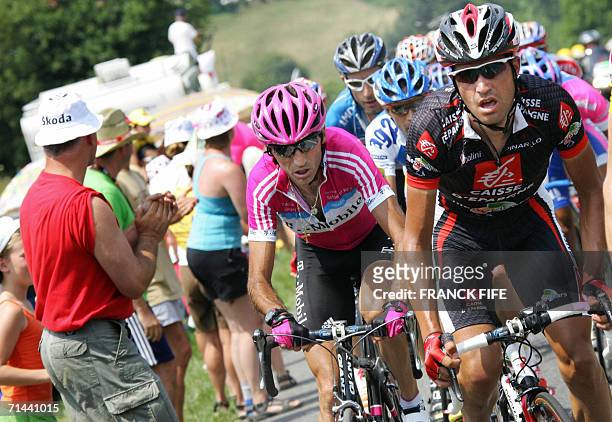Spain's David Arroyo Duran rides in front of Italy's Giuseppe Guerini during the 211.5 km twelfth stage of the 93rd Tour de France cycling race from...