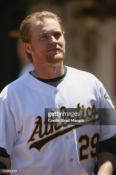 Dan Johnson of the Oakland Athletics stands in the dugout during the game against the Arizona Diamondbacks at the Network Associates Coliseum in...