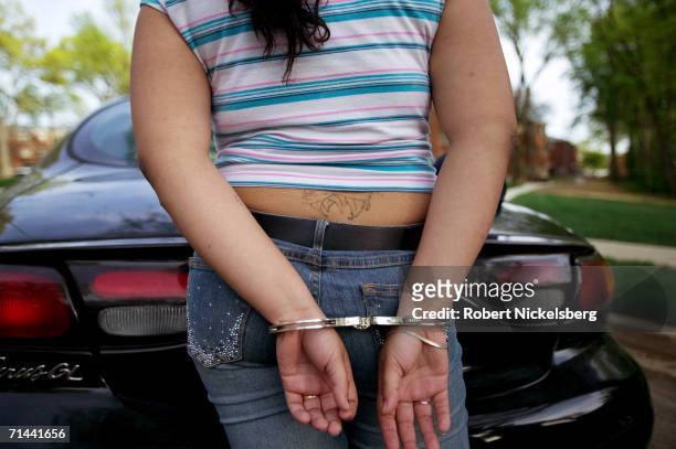 Armed police from Maryland's Prince George's County Anti-Gang Unit question and detain the girlfriend of a confirmed gang member of Mara Salvatrucha...
