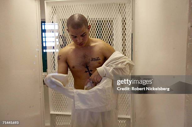 Daniel Flores, 24 years, shows off his tattoos from a visiting cell in the Robertson Unit maximum security prison on January 11, 2006 in Abilene,...