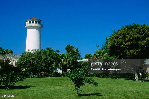 side view of a lighthouse at lucayan beach resort, freeport, grand bahamas, bahamas - freeport bahamas stock pictures, royalty-free photos & images