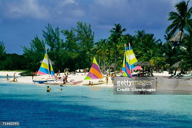 colorful yachts seen on a seashore, treasure island, abaco, bahamas - abaco stock pictures, royalty-free photos & images