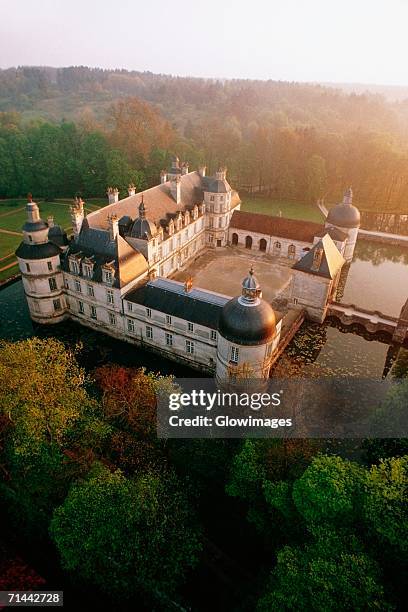 high angle view of tanlay chateau surrounded by trees, burgundy, france - castle france stock-fotos und bilder