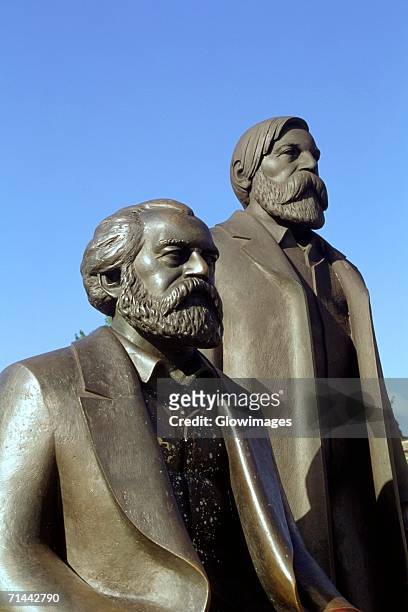 close-up of two statues, marx and engle statues, berlin, germany - karl marx stock pictures, royalty-free photos & images