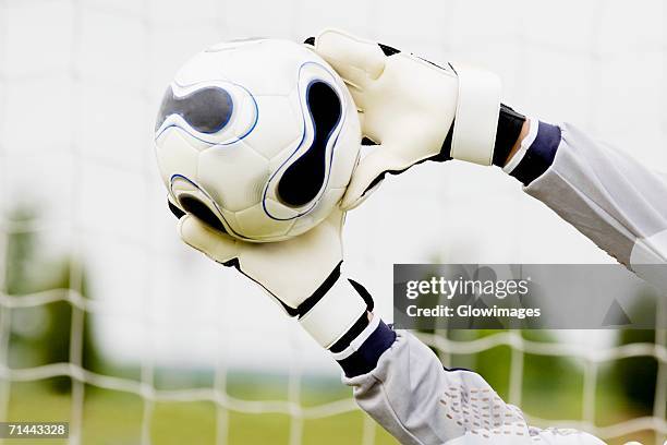 close-up of a goalie's hands making a save - goalkeeper gloves stock pictures, royalty-free photos & images