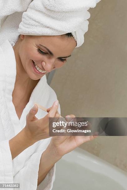 close-up of a young woman filing her fingernails - nail file stock pictures, royalty-free photos & images