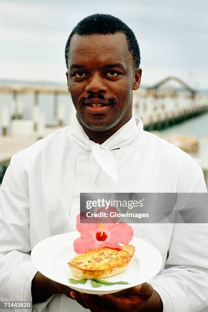 phillip bethel holding a garnished dish, abaco, bahamas - abaco stock pictures, royalty-free photos & images