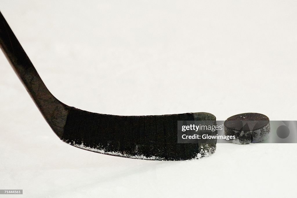 Close-up of an ice hockey stick with a hockey puck