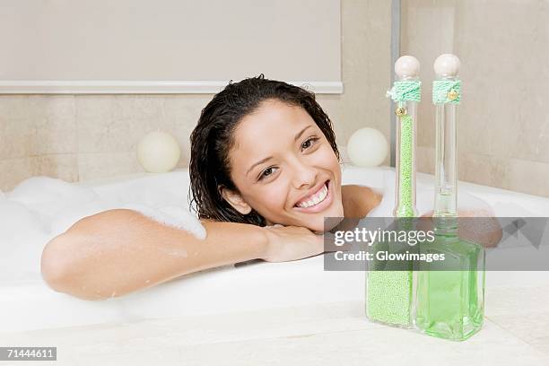 portrait of a teenage girl having a bath - bubble bath bottle stock pictures, royalty-free photos & images