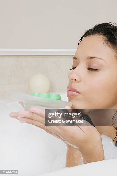 side profile of a teenage girl holding a soap dish - bubble bath bottle stock pictures, royalty-free photos & images