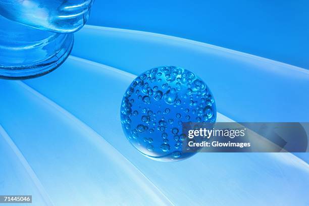 close-up of a glass paperweight in front of a glass mannequin - paperweight stock pictures, royalty-free photos & images