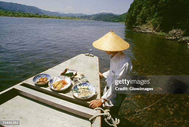 mature man standing near a boat, shimanto river, kochi, shikoku, japan - präfektur kochi stock-fotos und bilder