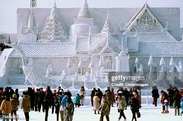 tourist in front of a snow sculpture, bangkok's royal palace, snow festival, sapporo, japan - snow festival stock-fotos und bilder