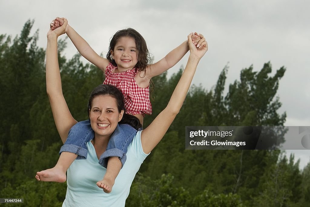 Portrait of a girl sitting on her mother's shoulder