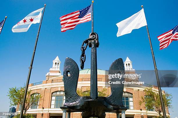 low angle view of the flags in front of a building, navy pier, chicago, illinois, usa - navy pier stock pictures, royalty-free photos & images