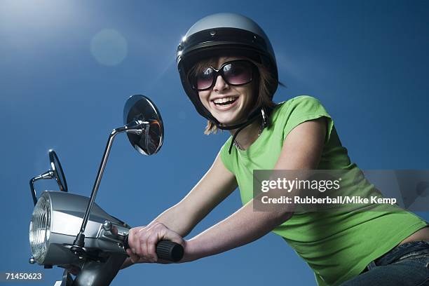 close-up of a teenage girl riding a scooter - crash helmet stock pictures, royalty-free photos & images